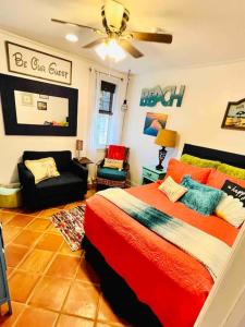 a bedroom with a large bed and a couch at Pearls Pad - Beautiful 1 bedroom apartment- 1 block to beach in Tybee Island