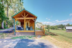 a gazebo with a porch and chairs in a yard at Deimos Cabin in Mars Hill