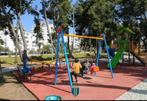 a group of children playing on a playground at M & A Apartment Bar A 29 in Bar