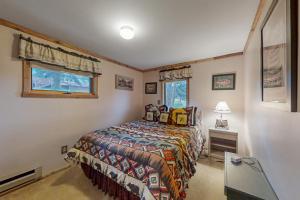 a bedroom with a bed and a window at Deer Mountain Lodge South in Estes Park
