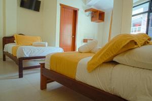 Voodi või voodid majutusasutuse Hostal CañaLimeña toas