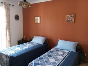 two beds sitting next to each other in a room at Chez Mamiyo in Gallargues-Le-Montueux