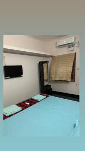 a room with a bed and a window and avertisement at VN GRAND RESIDENCY in Kottakupam