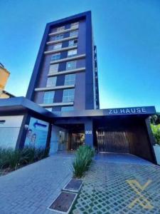 a building with a sign that reads house at Brisa do Vale Loft 802 - Prox Centro e Oktoberfest - Piscina e WiFi in Blumenau