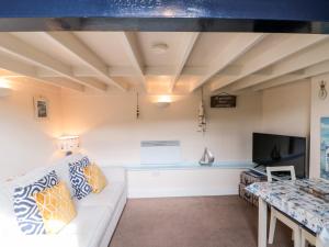 a living room with a couch and a tv at Nutshell in Whitby +13 photos