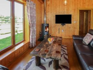 - un salon avec un canapé et une table basse dans l'établissement Barn Shelley Lodge, à Copplestone