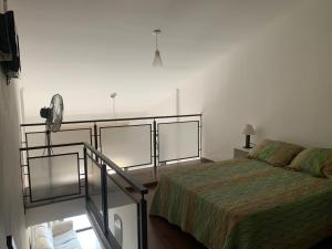 a bedroom with a bed and a staircase in it at Loft Pedro Méndez 20408C in Posadas