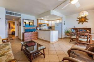 a living room with a couch and a table and a kitchen at KIHEI BEACH, #507 condo in Kihei