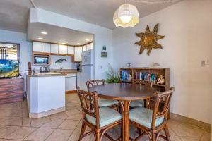 a kitchen and dining room with a table and chairs at KIHEI BEACH, #507 condo in Kihei +17 photos