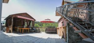 an outdoor patio with a table and an umbrella at Dom Adonis in Dilijan