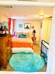 a bedroom with a bed and a blue rug at Mini Pearl, Private 2 BR - 1 block to BEACH! in Tybee Island