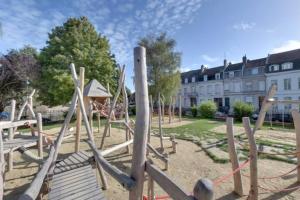 a park with a playground with wooden logs at LeRelaisdOdile CAMBRAI - HYPER CENTRE - Free Wifi in Cambrai