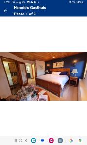 a bedroom with a large bed and a table at Hannie's Gasthuis in Blind Bay