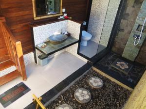 an overhead view of a bathroom with a sink and a toilet at The Jingga Villas in Nusa Lembongan +28 photos