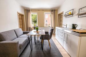 a living room with a couch and a table at sehusa living in Seesen +37 photos