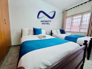 Voodi või voodid majutusasutuse Infinity Hotel Kampala toas