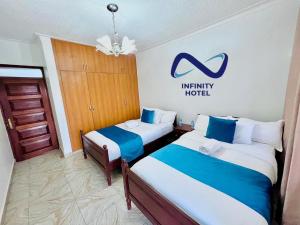 Voodi või voodid majutusasutuse Infinity Hotel Kampala toas