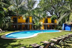 a swimming pool in front of a resort at Villas Macondo in Tamarindo