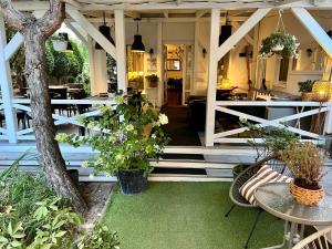 a porch with a table and chairs and plants at Rezydencja Pod Tężnią & SPA in Inowrocław +65 photos