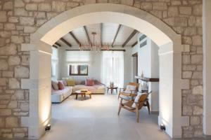 an archway in a living room with a stone wall at Sea View Villa Mia Casa with Private Pool, Ping-Pong & BBQ in Langá