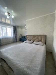 a bedroom with a bed and a ceiling fan at ЖК ПРЕСТИЖ 1 комнатная квартира in Kokshetau