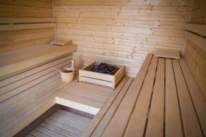 an inside of a sauna with a box of blueberries at Apartamenty Łeba - Polanki23 - basen, sauna, kino in Łeba