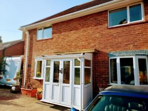 a red brick house with a white door at Bowtree House Bed and Breakfast in Grantham
