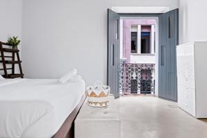 a bedroom with a bed and a chair and a door at Luxury Home - Rooftop Garden - Heart of Old San Juan in San Juan