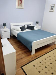 a bedroom with a bed and two night stands at Apartment Neda in Rabac