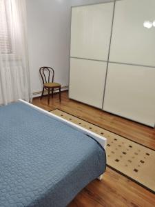 a bedroom with a bed and a dresser and a chair at Apartment Neda in Rabac