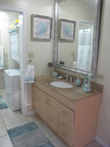 a bathroom with a sink and a mirror at Fabulous one bedroom in West Bay in West Bay