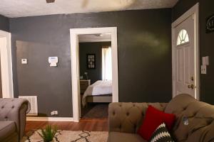 a living room with a couch and a bedroom at Couple Getaway 5 mins from Downtown in Knoxville