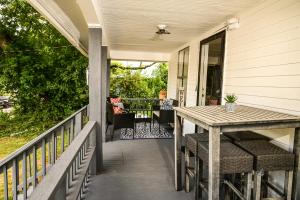 a porch with a table and chairs on a house at Couple Getaway 5 mins from Downtown in Knoxville