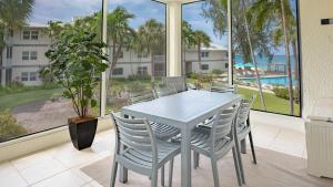 a dining room with a table and chairs and a window at Tamarind Bay 3BD on Seven Mile Beach in George Town