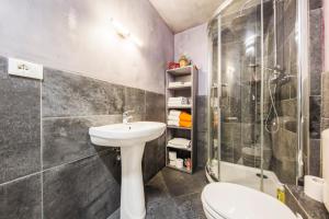 um banheiro com pia, chuveiro e vaso sanitário em Art Gallery Apartment em Génova