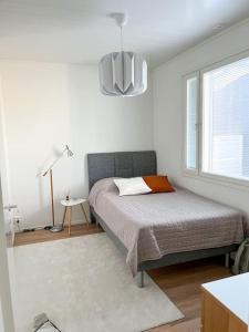 a bedroom with a bed and a large window at Big apartment, near Santaclaus Village in Rovaniemi