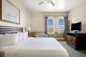 a hotel room with a large bed and a flat screen tv at Hotel St. Michael in Prescott