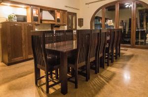 a wooden table and chairs in a room at Il-Bejta Farmhouse in Għarb