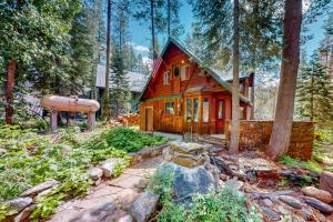 a log cabin in the woods with a garden at Sierra Secret in Soda Springs