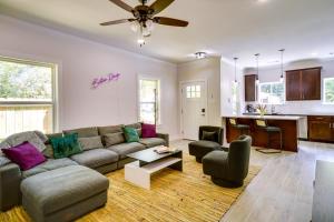 a living room with a couch and a table at MidCity Mural House in Baton Rouge 3 Mi to LSU! in Baton Rouge