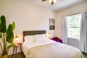 a bedroom with a white bed and a window at MidCity Mural House in Baton Rouge 3 Mi to LSU! in Baton Rouge