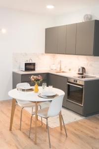 a kitchen with a table and chairs in a kitchen at K111 Klapka Apartment in Budapest