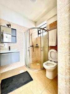 a bathroom with a shower and a toilet at Lovely 2bedroom Apartment overlooking Nairobi City in Nairobi