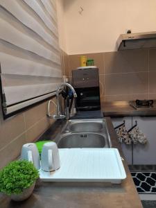 a kitchen counter top with a sink and a sink at M Centura Sentul 2 bedrooms with pool in Kuala Lumpur