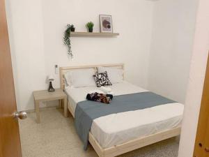 a bedroom with a bed and a table with a plant on it at Villa del Sol in Luquillo