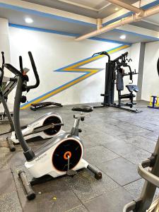a gym with several exercise bikes in a room at Lovely 2bedroom Apartment overlooking Nairobi City in Nairobi