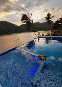 a swimming pool with a view of a beach at Villa frente al mar en Yelapa para 2 personas in Yelapa