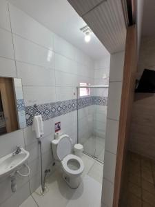 a bathroom with a toilet and a sink at Pousada Águas Marinhas in Maceió