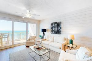 a living room with a couch and a table at High Pointe Resort in Panama City Beach
