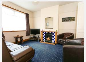 a living room with a couch and a fireplace at Fishermen Cottage - 5 star location- 90sq garden -2 living room- 2 bath room -pets friendly -comfortably sleep 5-6 people -50 percent off monthly -self check in in Deal